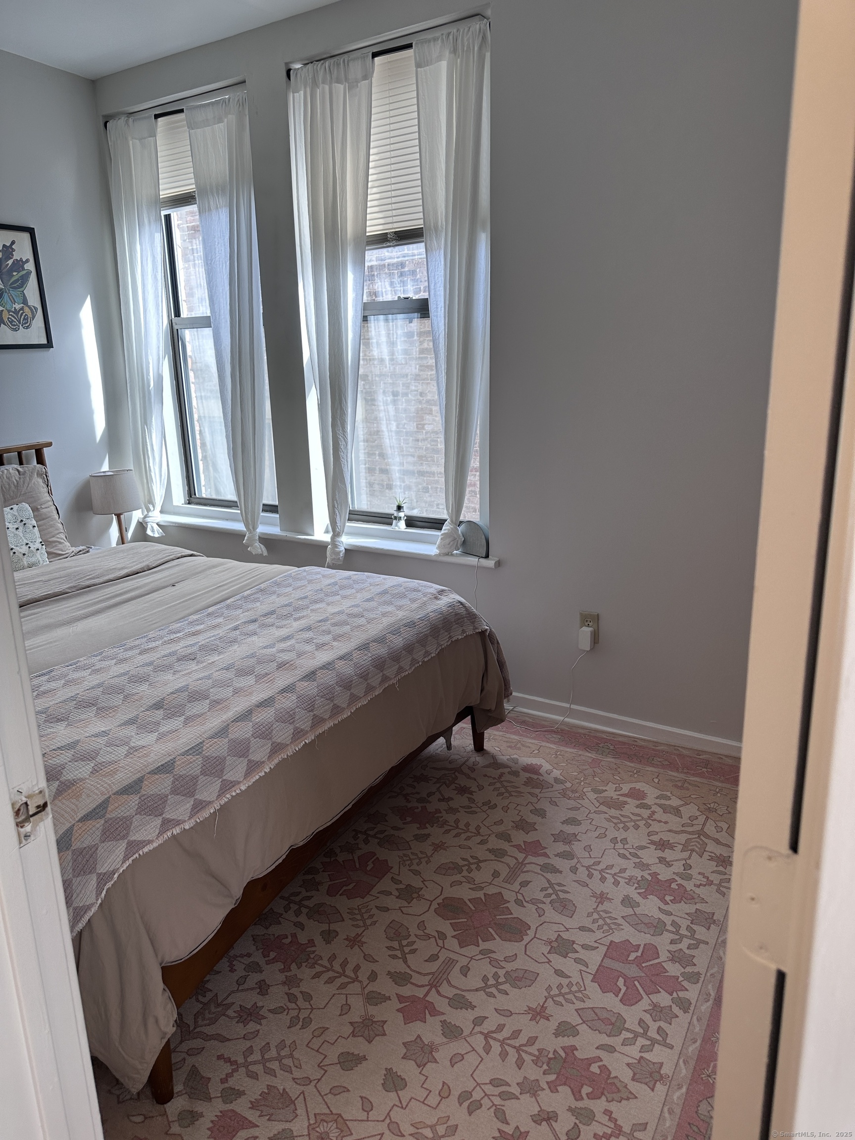 83 Washington Street, Unit 3B Norwalk, CT 06854 - Photo 3 of 12 a bedroom with a bed and a window