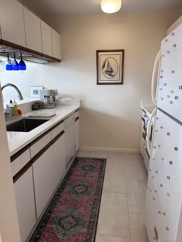 a kitchen with stainless steel appliances a sink a stove and cabinets