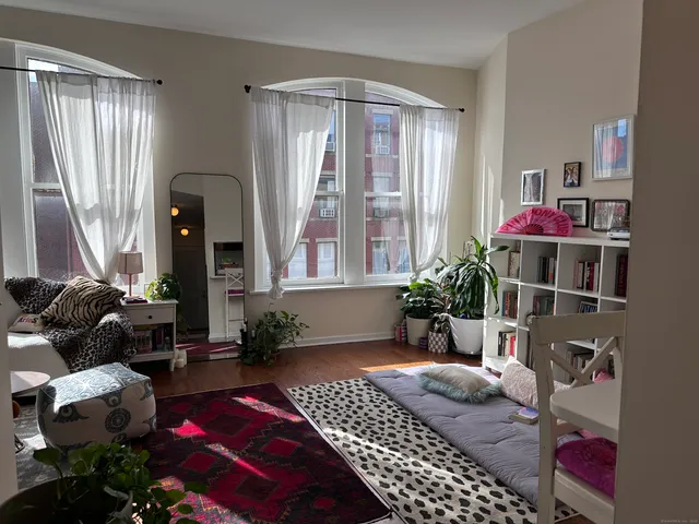 a bedroom with a bed and a potted plant