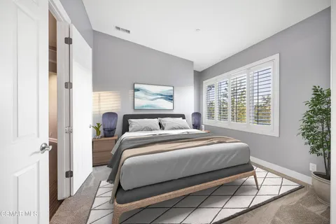 a bedroom with a bed and windows