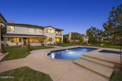 a view of a house with pool yard and a yard