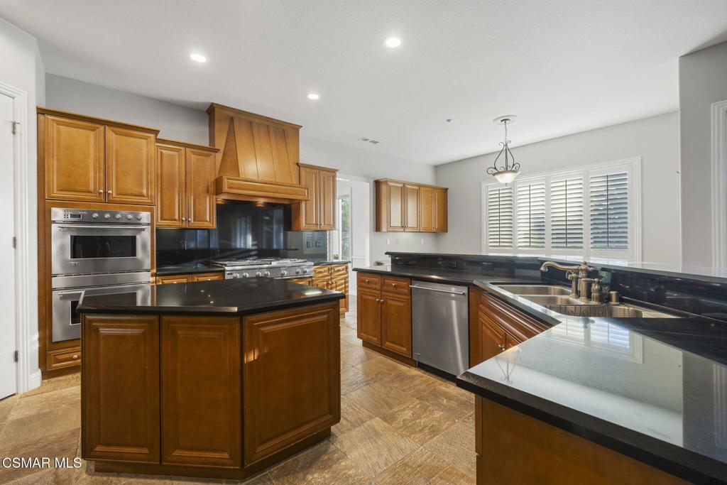 12364 Palmer Drive Moorpark, CA 93021 - Photo 6 of 31 a kitchen with stainless steel appliances granite countertop a stove a sink and a microwave