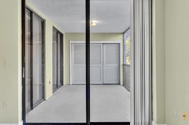 a view of a hallway with wooden shelves