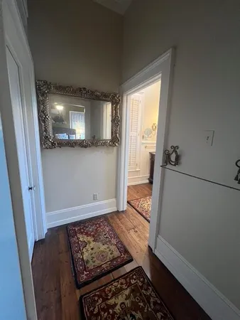 a view of a livingroom with wooden floor and floor to ceiling window