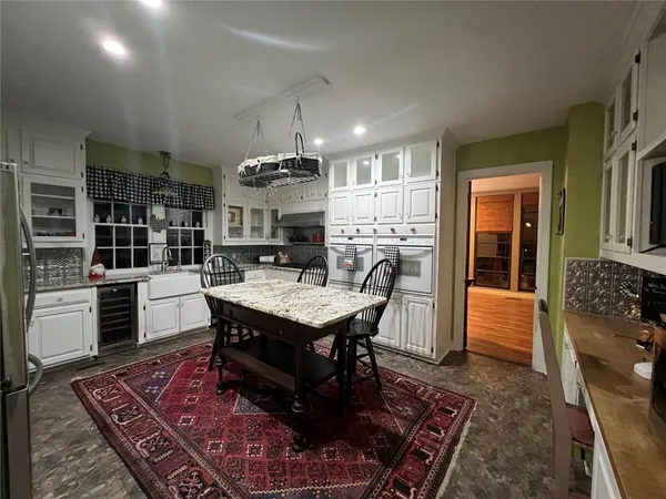a kitchen view with a table and chairs