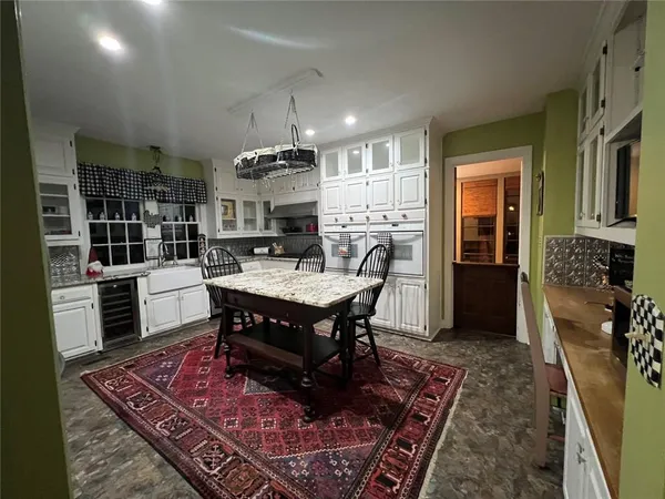 a view of a hallway with wooden floor and furniture