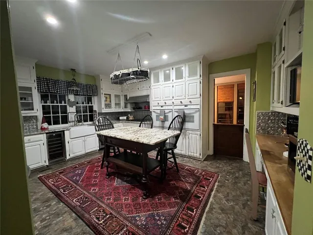 a view of a hallway with wooden floor and furniture
