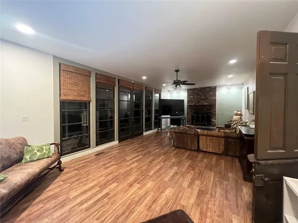 a living room with furniture a counter space and a wooden floor