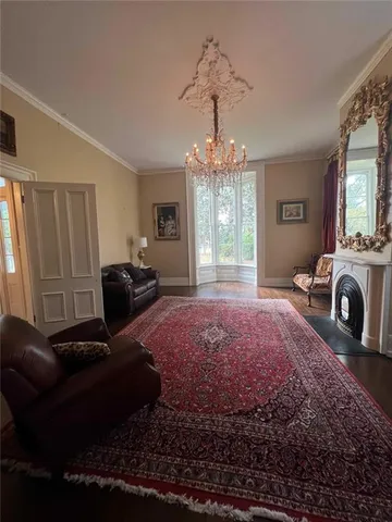 a living room with furniture and a chandelier
