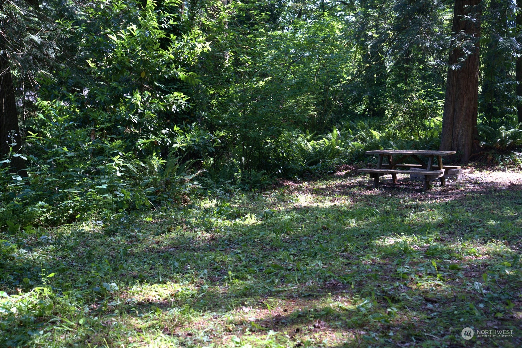 19313 Harris Avenue Northeast Suquamish, WA 98392 - Photo 3 of 6 a view of a bench in a garden