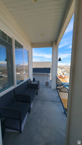 7689 Butterfield Road, Unit 274 Eagle Mountain, UT 84005 - Photo 22 of 25 Covered balcony featuring concrete flooring, a white paneled ceiling with recessed lighting, and black metal railings