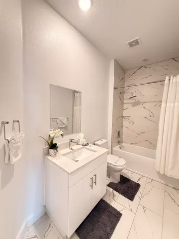 a bedroom with a bed a couch and a window