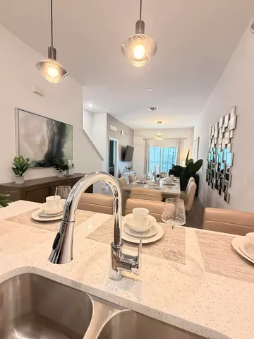 a dining room with furniture and a chandelier