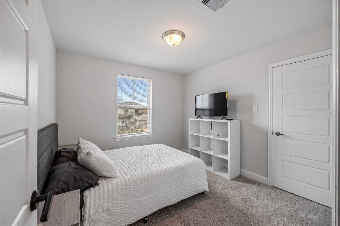 32906 Ruthie Dean Drive Brookshire, TX 77423 - Photo 13 of 23 a bedroom with a bed and flat screen tv