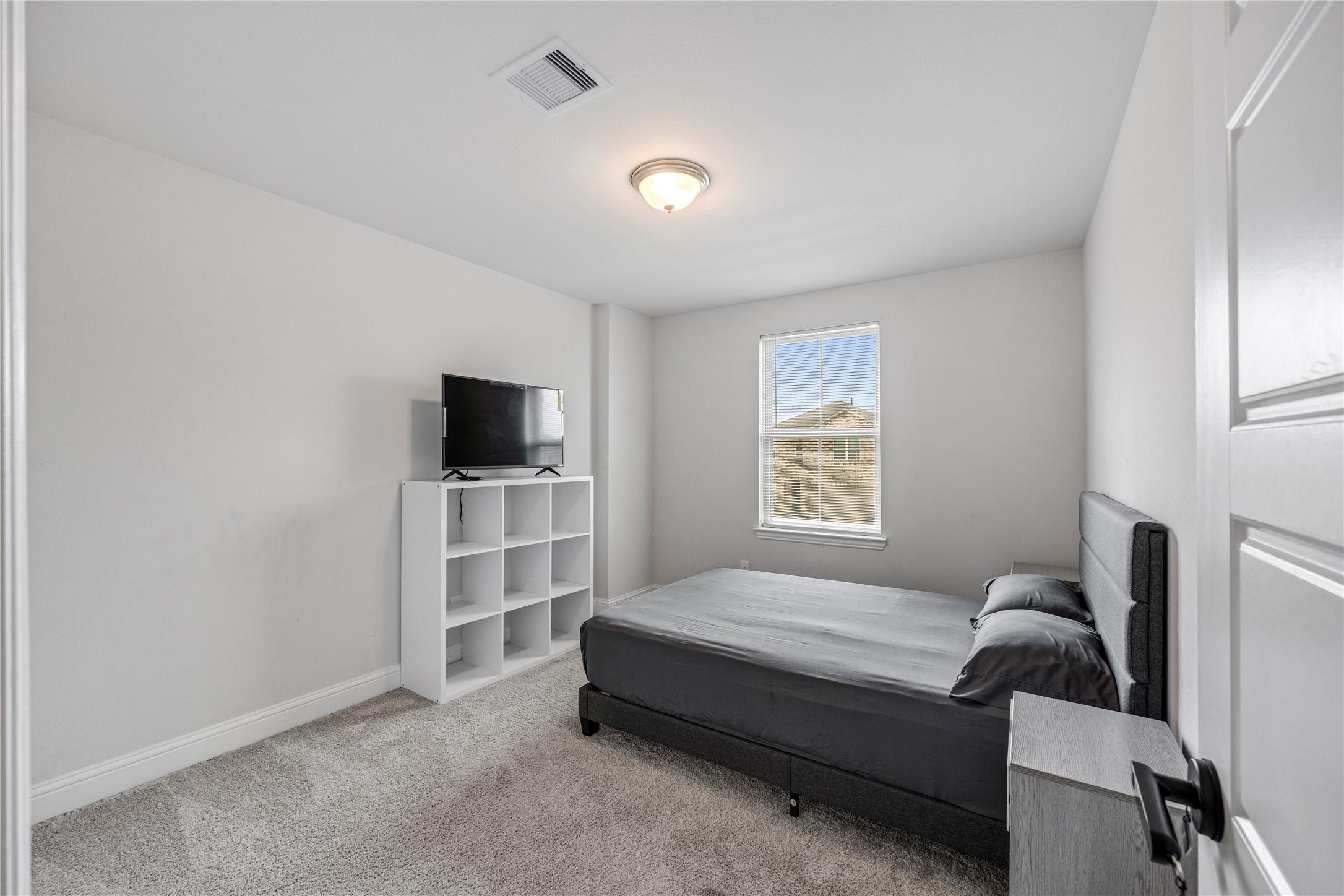 32906 Ruthie Dean Drive Brookshire, TX 77423 - Photo 14 of 23 a spacious bedroom with a bed and a flat screen tv