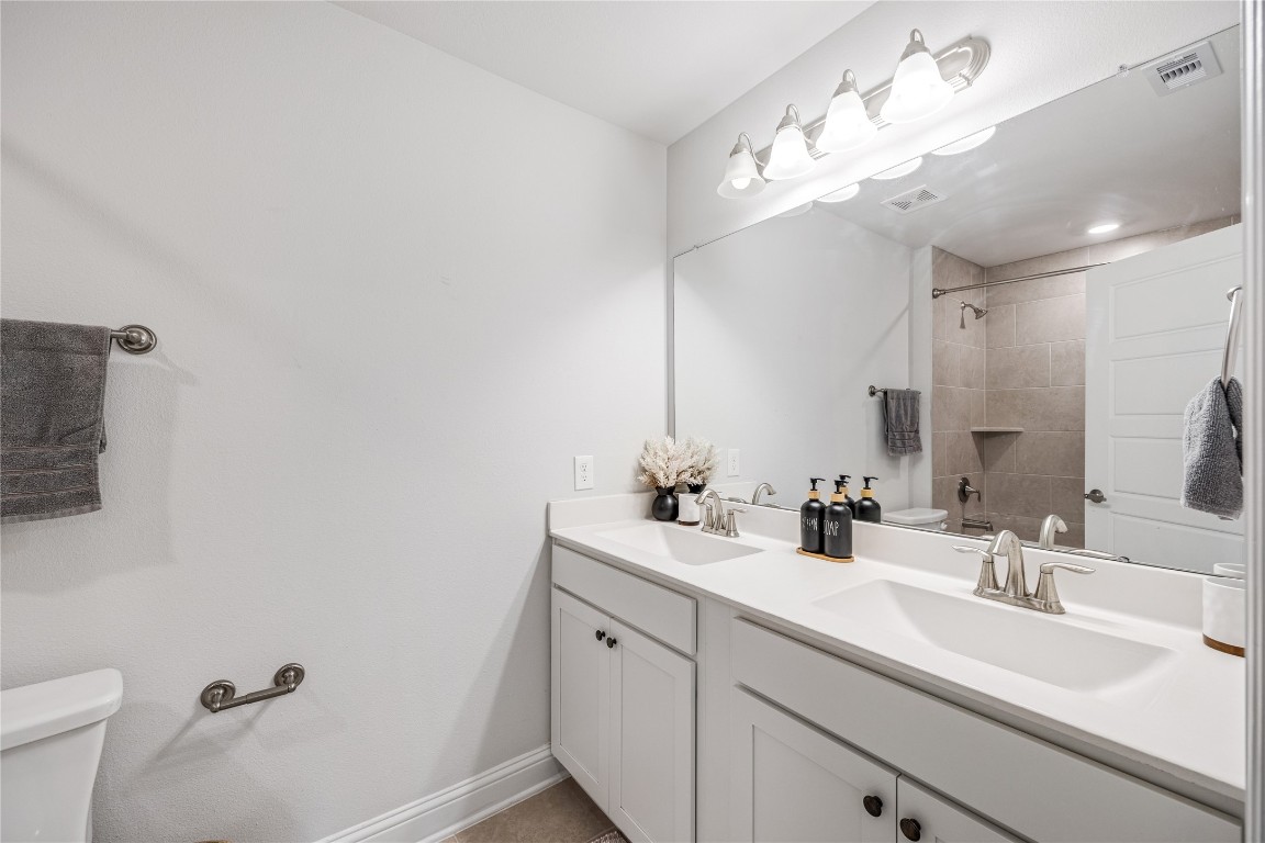 32906 Ruthie Dean Drive Brookshire, TX 77423 - Photo 15 of 23 a bathroom with a double vanity sink and a mirror
