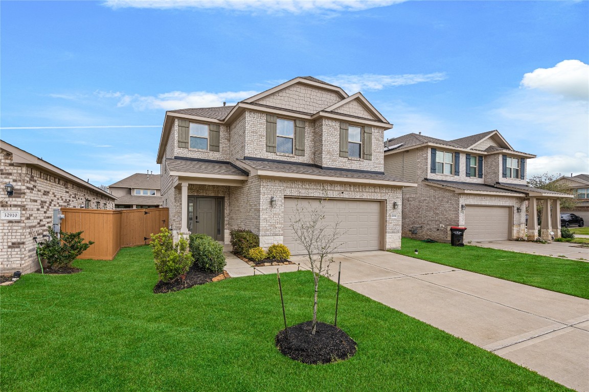 32906 Ruthie Dean Drive Brookshire, TX 77423 - Photo 2 of 23 a front view of a house with a yard and garage