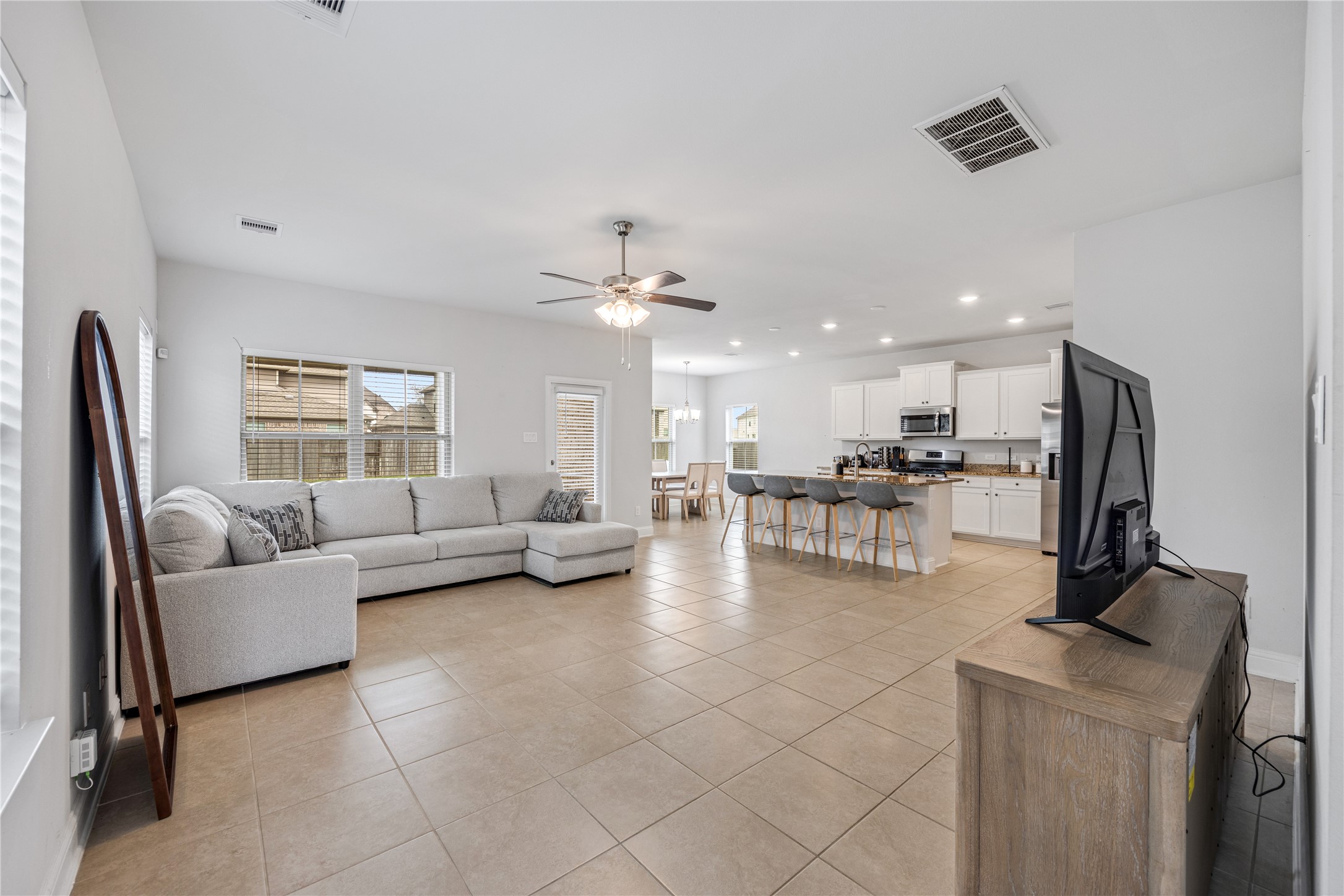 32906 Ruthie Dean Drive Brookshire, TX 77423 - Photo 5 of 23 a living room with couches and kitchen view with wooden floor