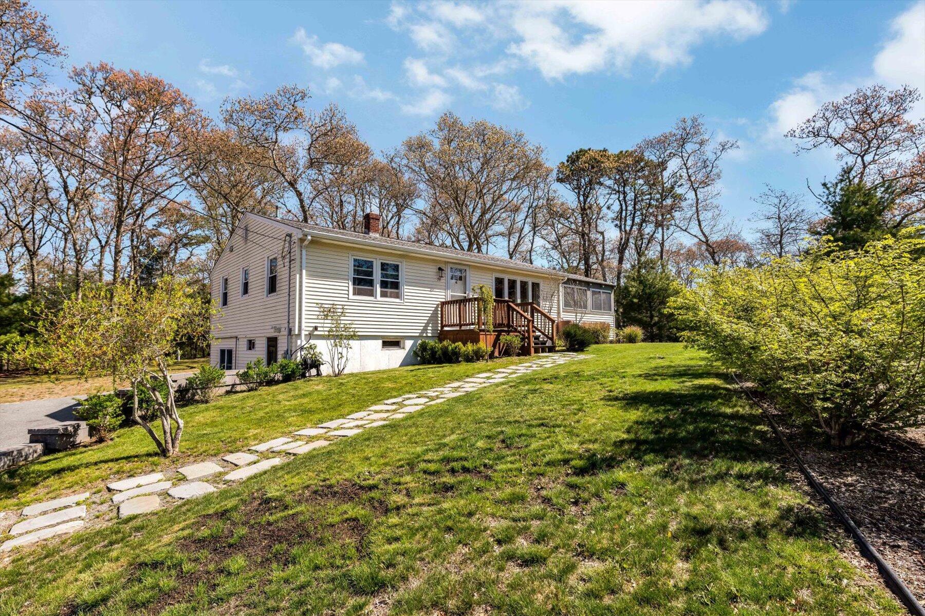 79 Clay Pond Road Monument Beach, MA 02532 - Photo 1 of 46 a view of a house with backyard and sitting area