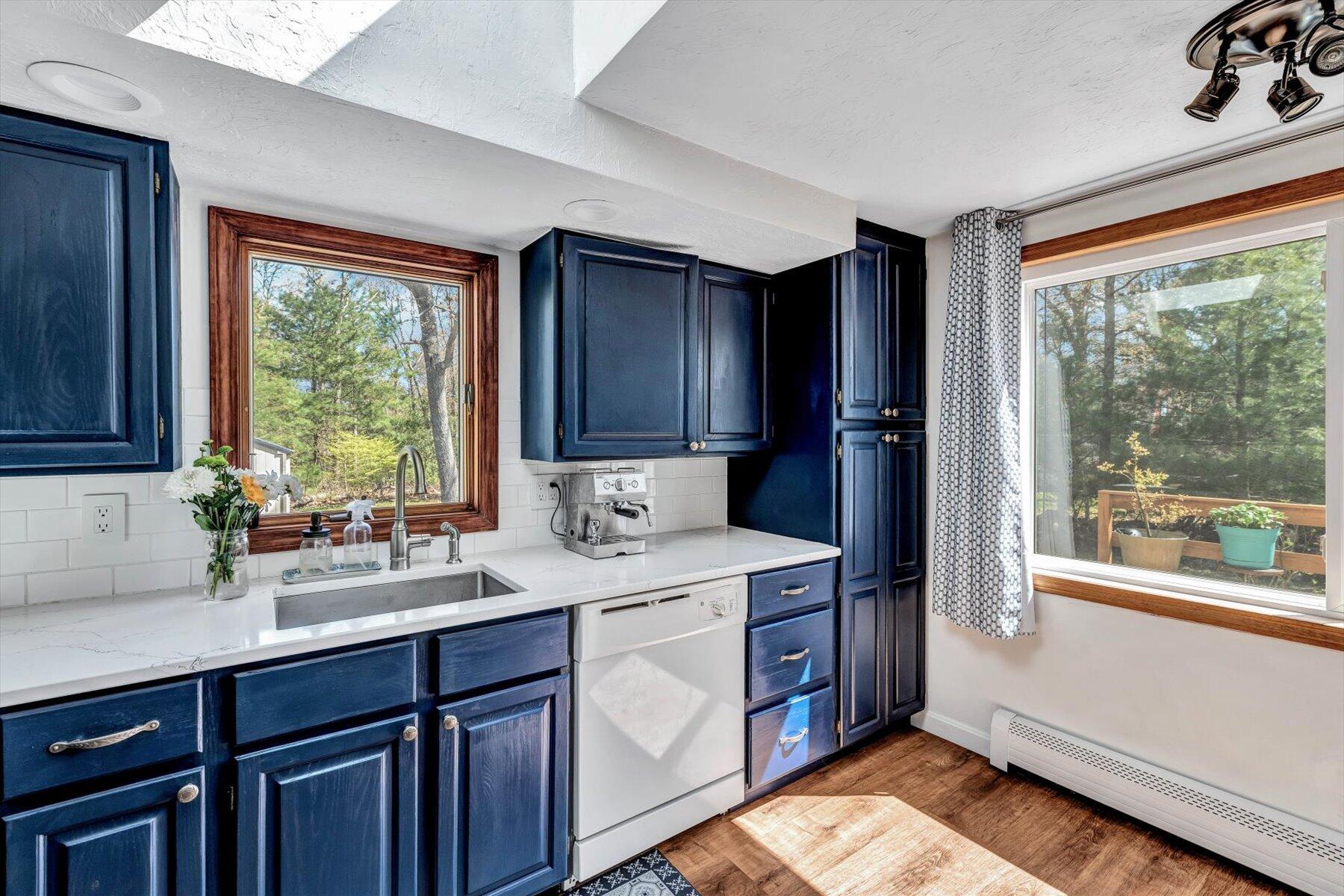 79 Clay Pond Road Monument Beach, MA 02532 - Photo 11 of 46 a kitchen with a sink window and cabinets