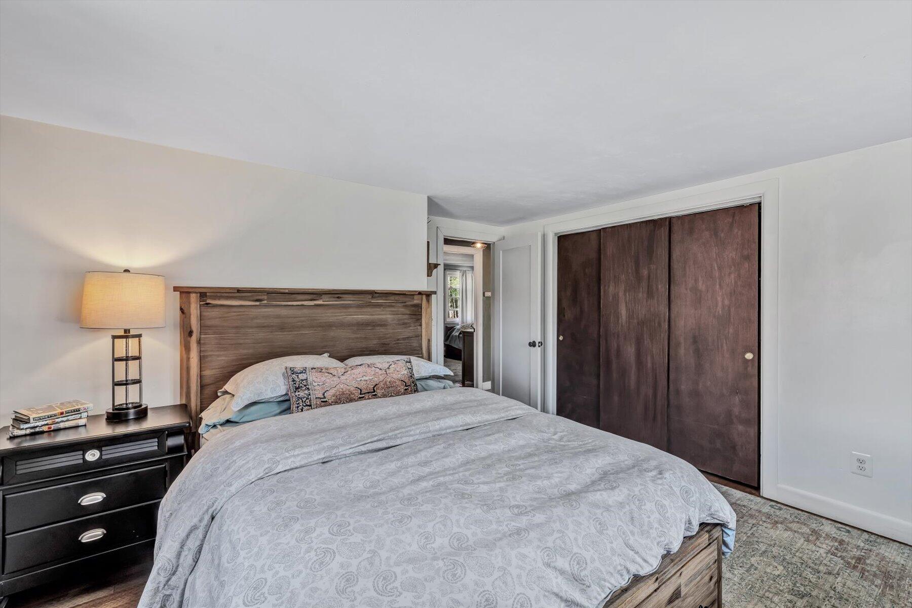 79 Clay Pond Road Monument Beach, MA 02532 - Photo 15 of 46 a bedroom with a bed and a lamp