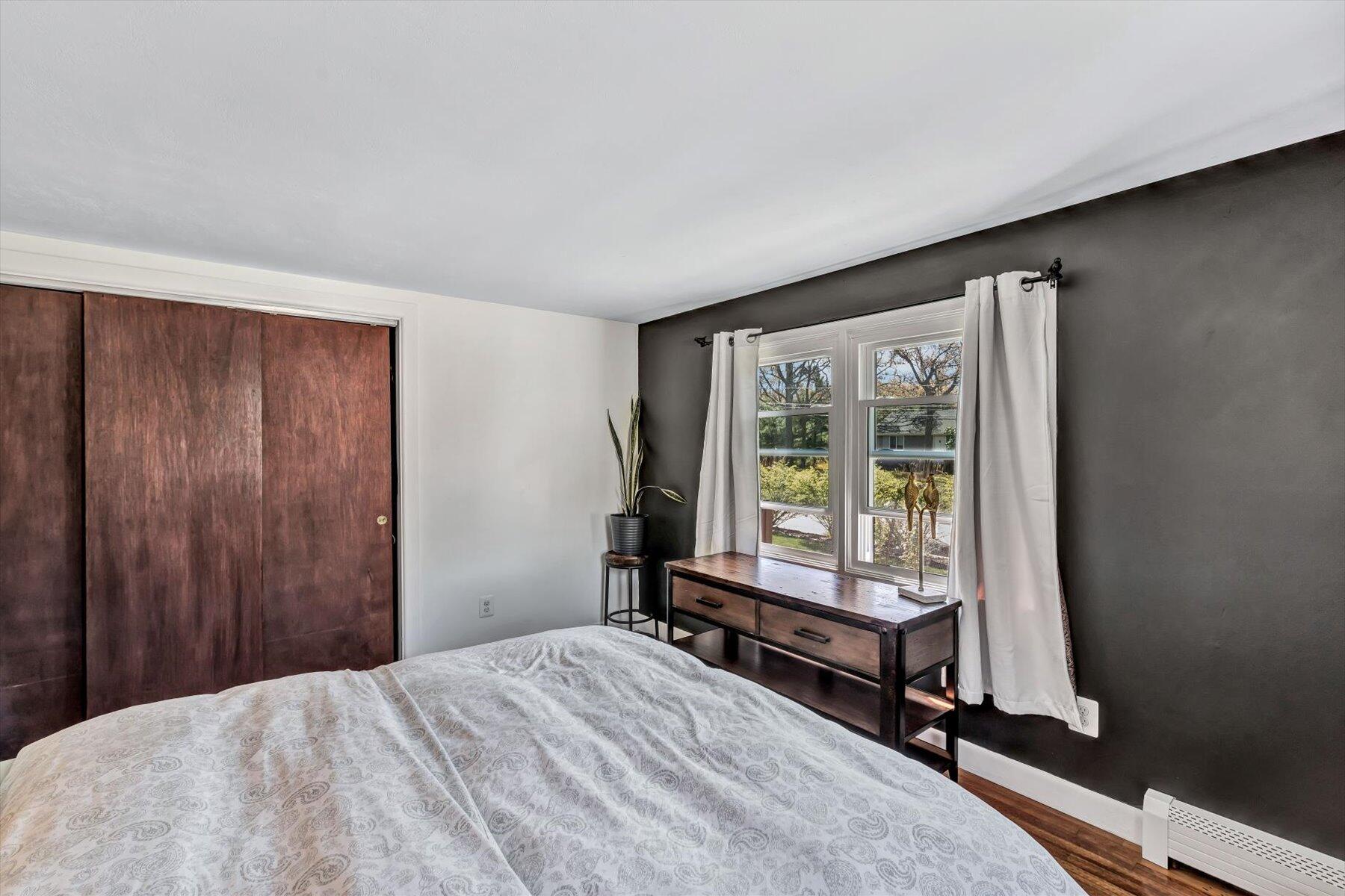 79 Clay Pond Road Monument Beach, MA 02532 - Photo 16 of 46 a bed room with a bed and a window