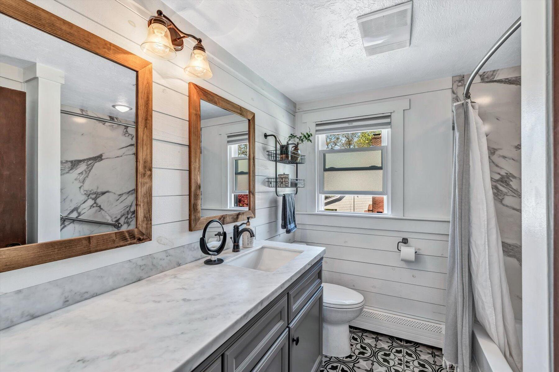 79 Clay Pond Road Monument Beach, MA 02532 - Photo 18 of 46 a bathroom with a granite countertop sink a toilet and a shower
