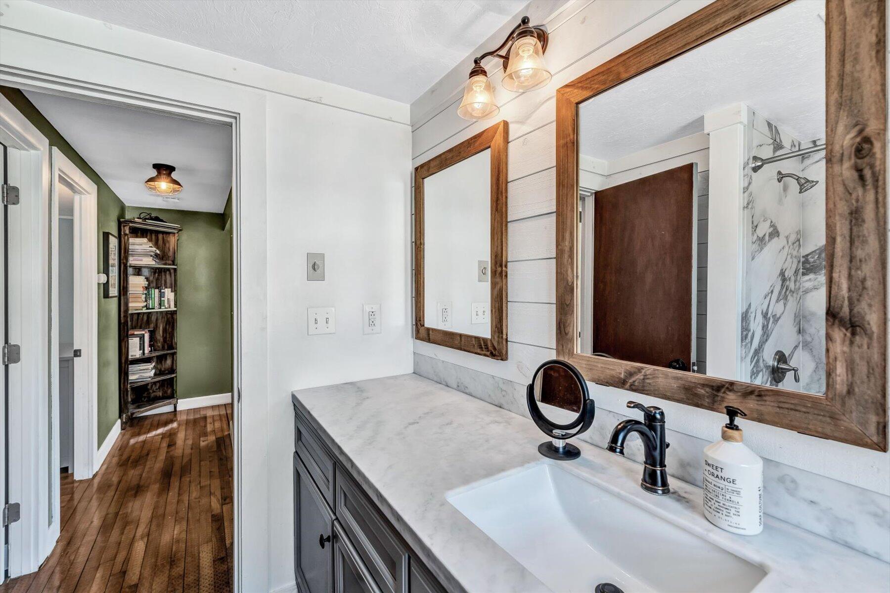 79 Clay Pond Road Monument Beach, MA 02532 - Photo 20 of 46 a bathroom with a granite countertop sink and a mirror