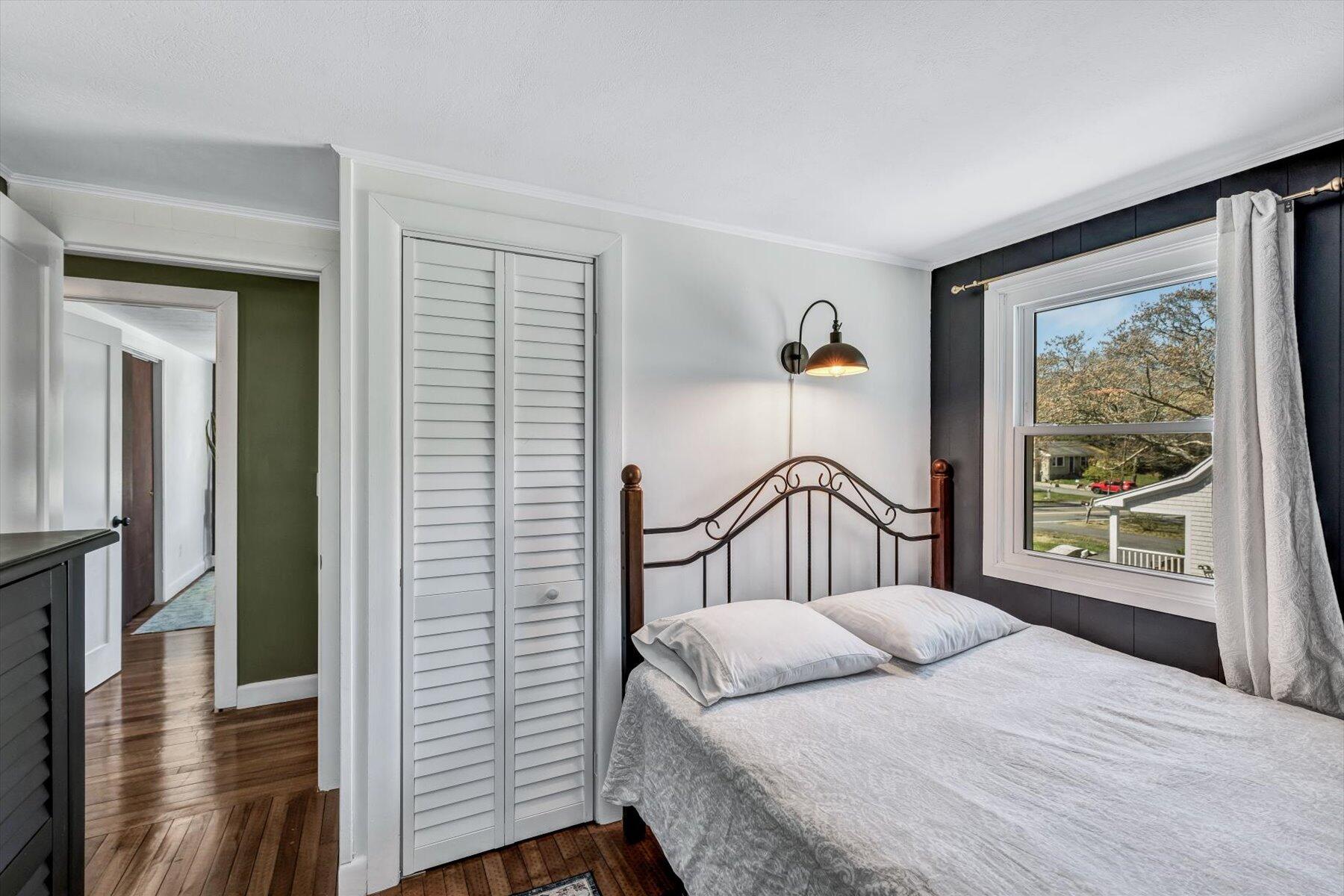 79 Clay Pond Road Monument Beach, MA 02532 - Photo 22 of 46 a bedroom with a bed and a large window
