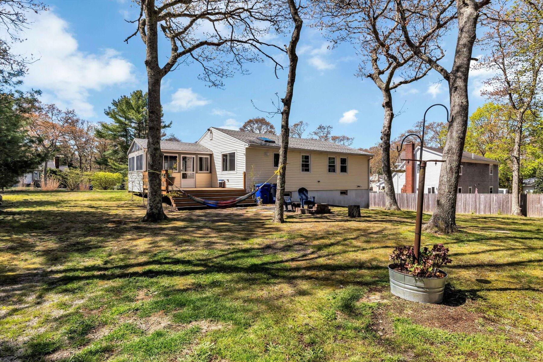 79 Clay Pond Road Monument Beach, MA 02532 - Photo 33 of 46 a view of a house with a yard patio and fire pit