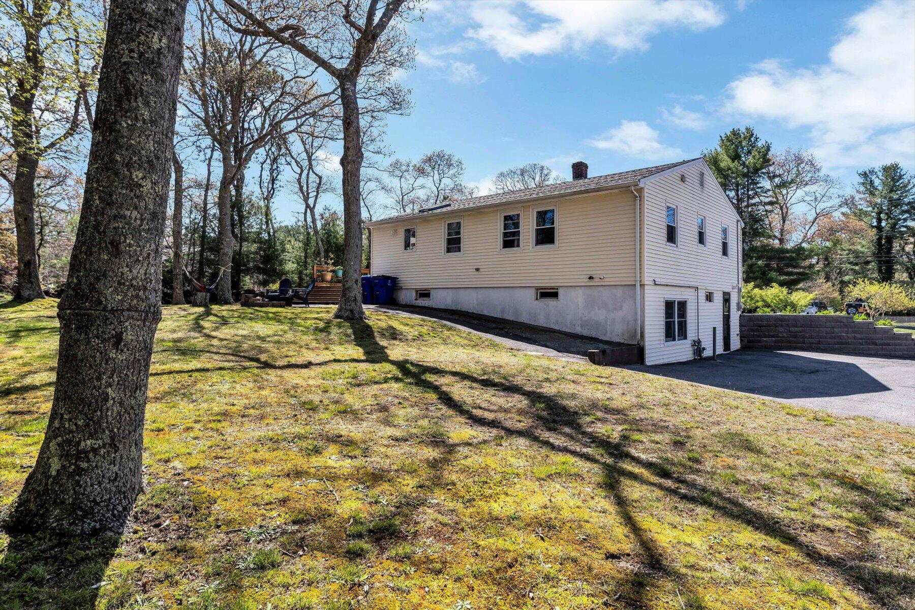 79 Clay Pond Road Monument Beach, MA 02532 - Photo 36 of 46 a view of a house with a yard