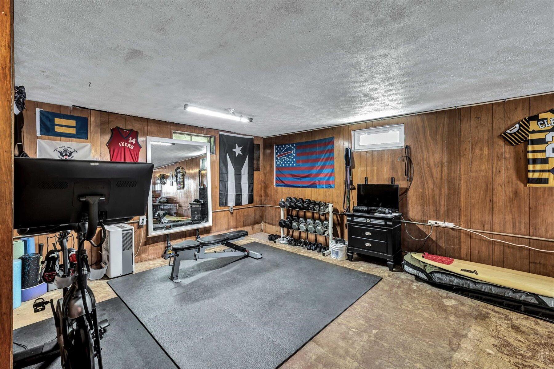 79 Clay Pond Road Monument Beach, MA 02532 - Photo 41 of 46 a room with gym equipment and a flat screen tv
