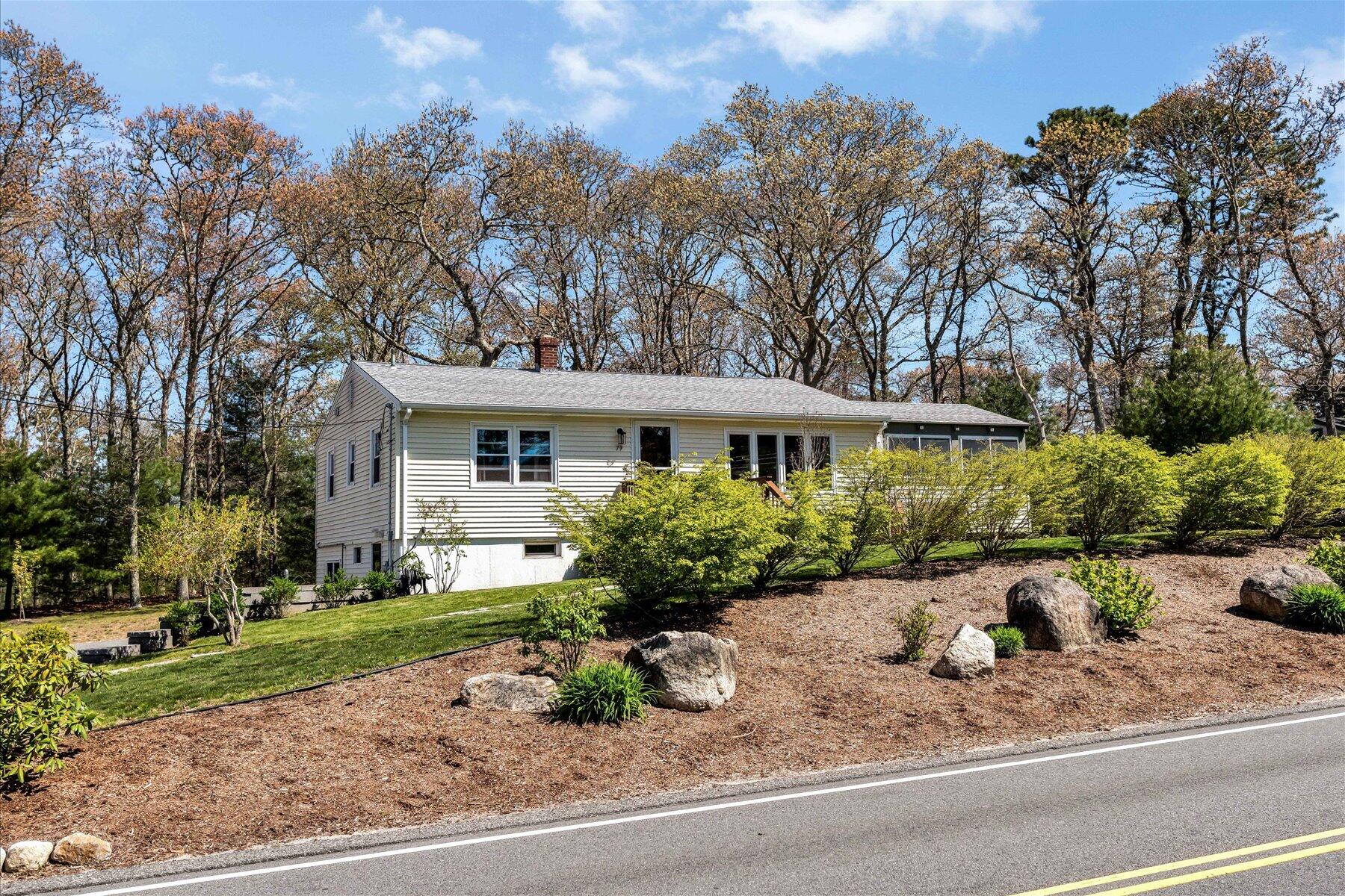 79 Clay Pond Road Monument Beach, MA 02532 - Photo 46 of 46 a front view of a house with garden and plants