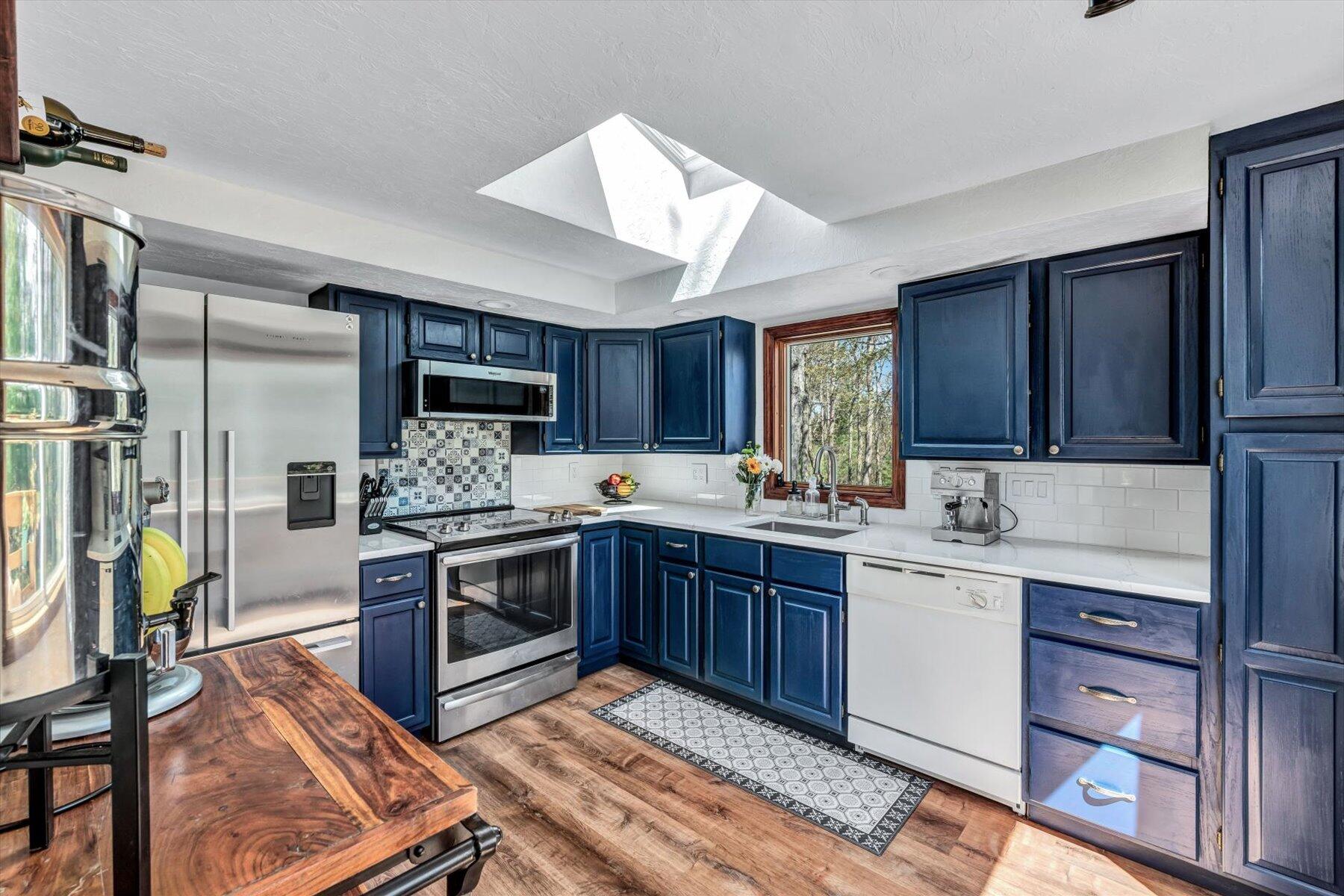 79 Clay Pond Road Monument Beach, MA 02532 - Photo 9 of 46 a kitchen with a sink cabinets and stainless steel appliances