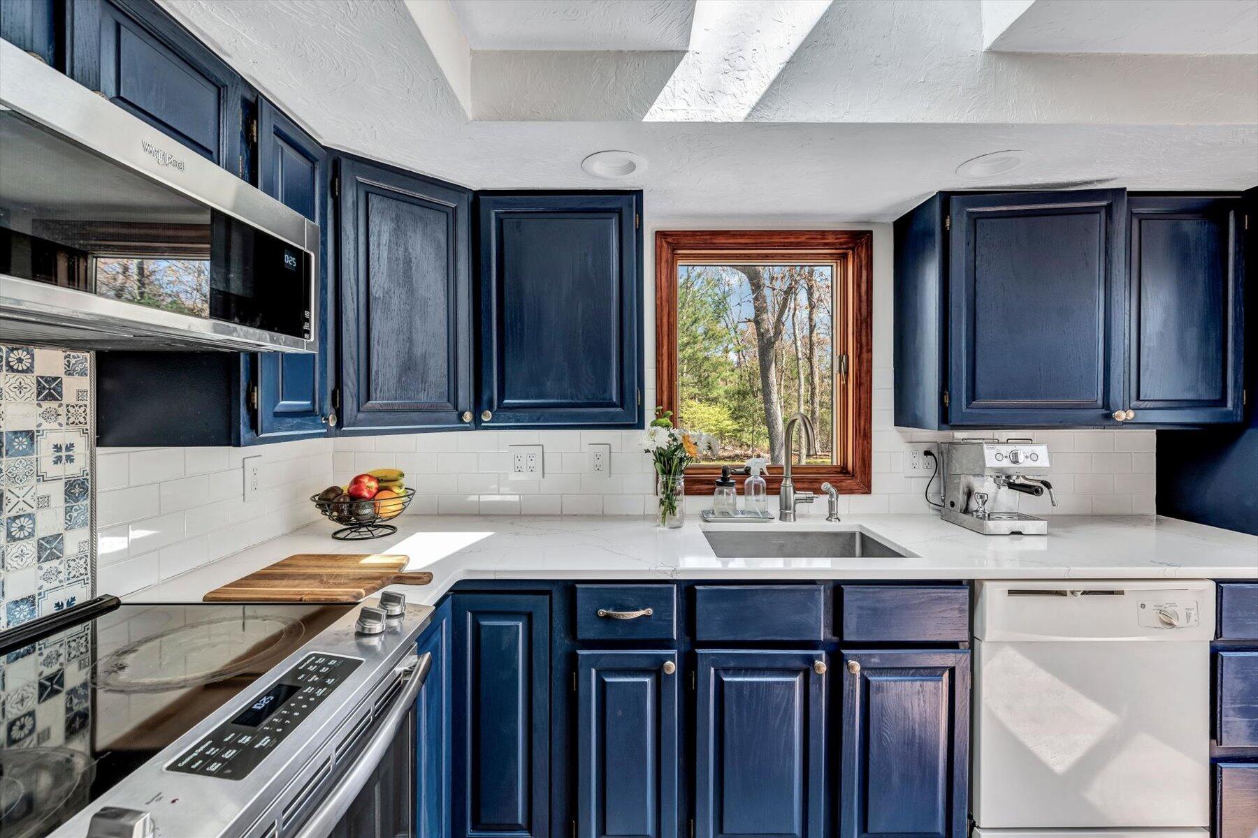 79 Clay Pond Road Monument Beach, MA 02532 - Photo 10 of 46 a kitchen with stainless steel appliances a sink stove and cabinets