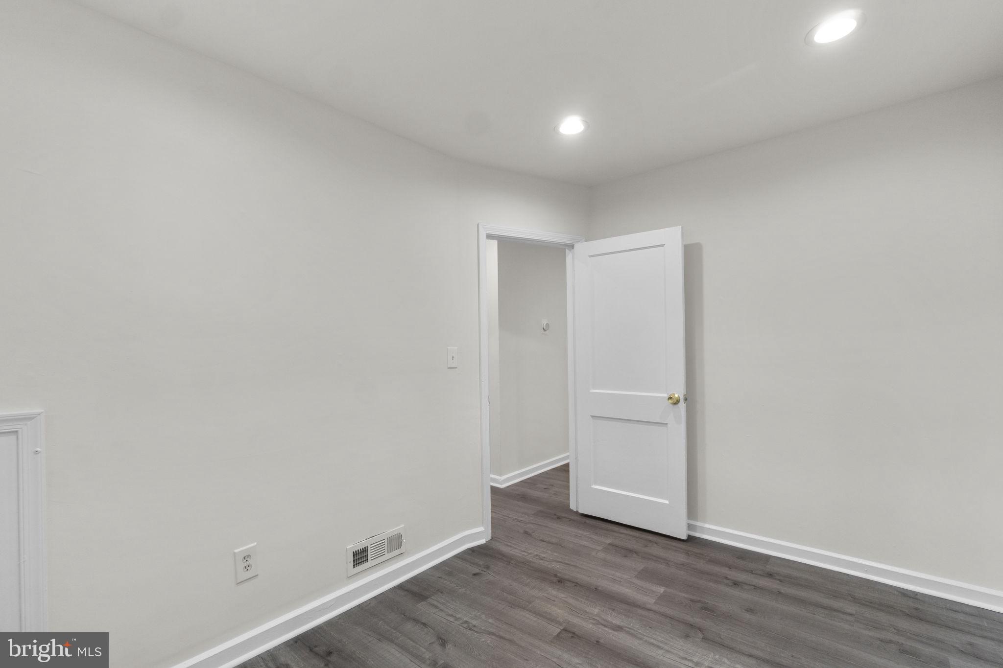 3658 Clifmar Road Baltimore, MD 21244 - Photo 30 of 43 a view of an empty room with wooden floor
