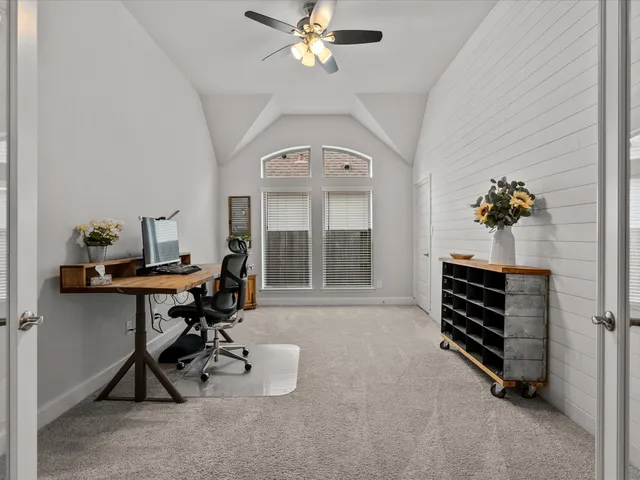 a view of room with workspace and windows