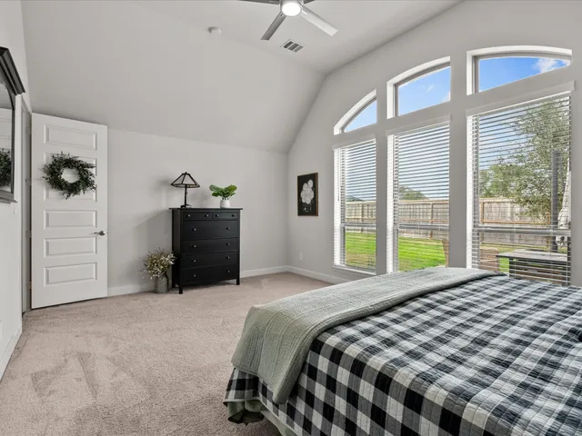 a bedroom with a bed and a large window
