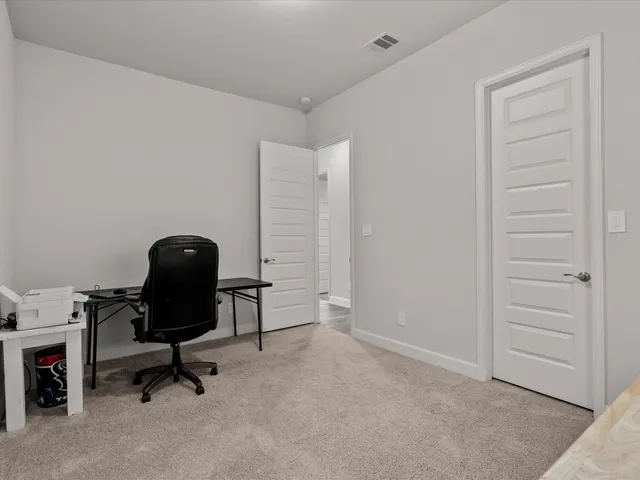 a view of a workspace with furniture