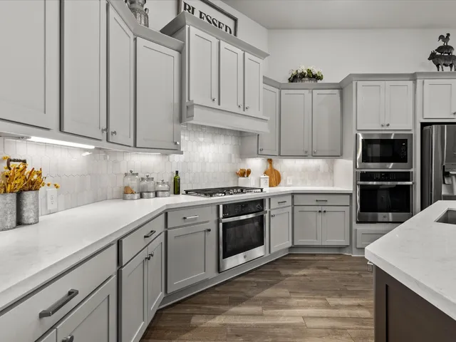 a kitchen with cabinets appliances and a counter space