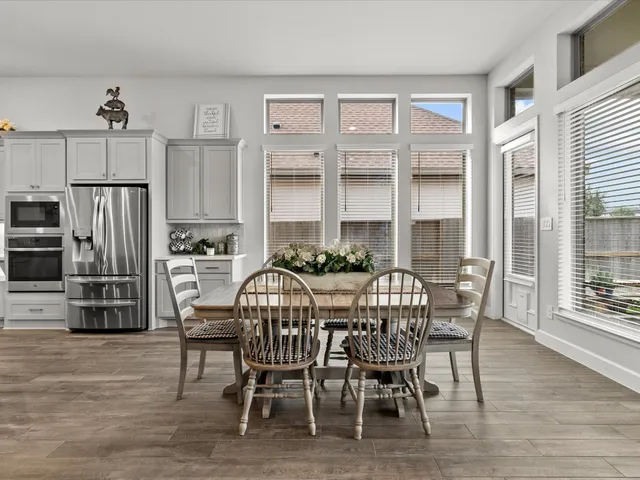 a view of a dining room with furniture and wooden floor