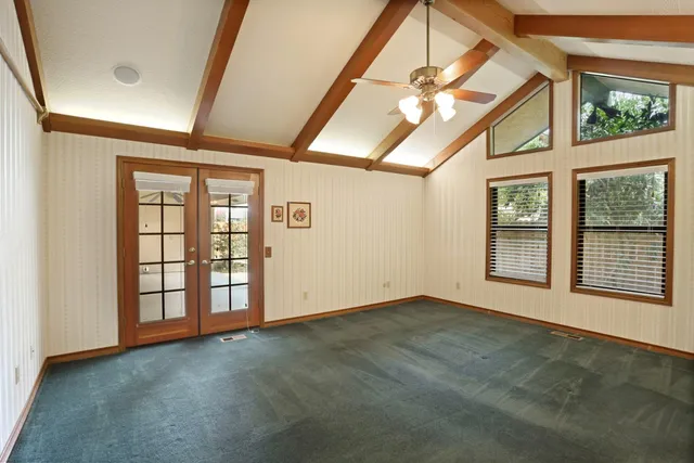 a bathroom with a granite countertop sink a mirror and a shower