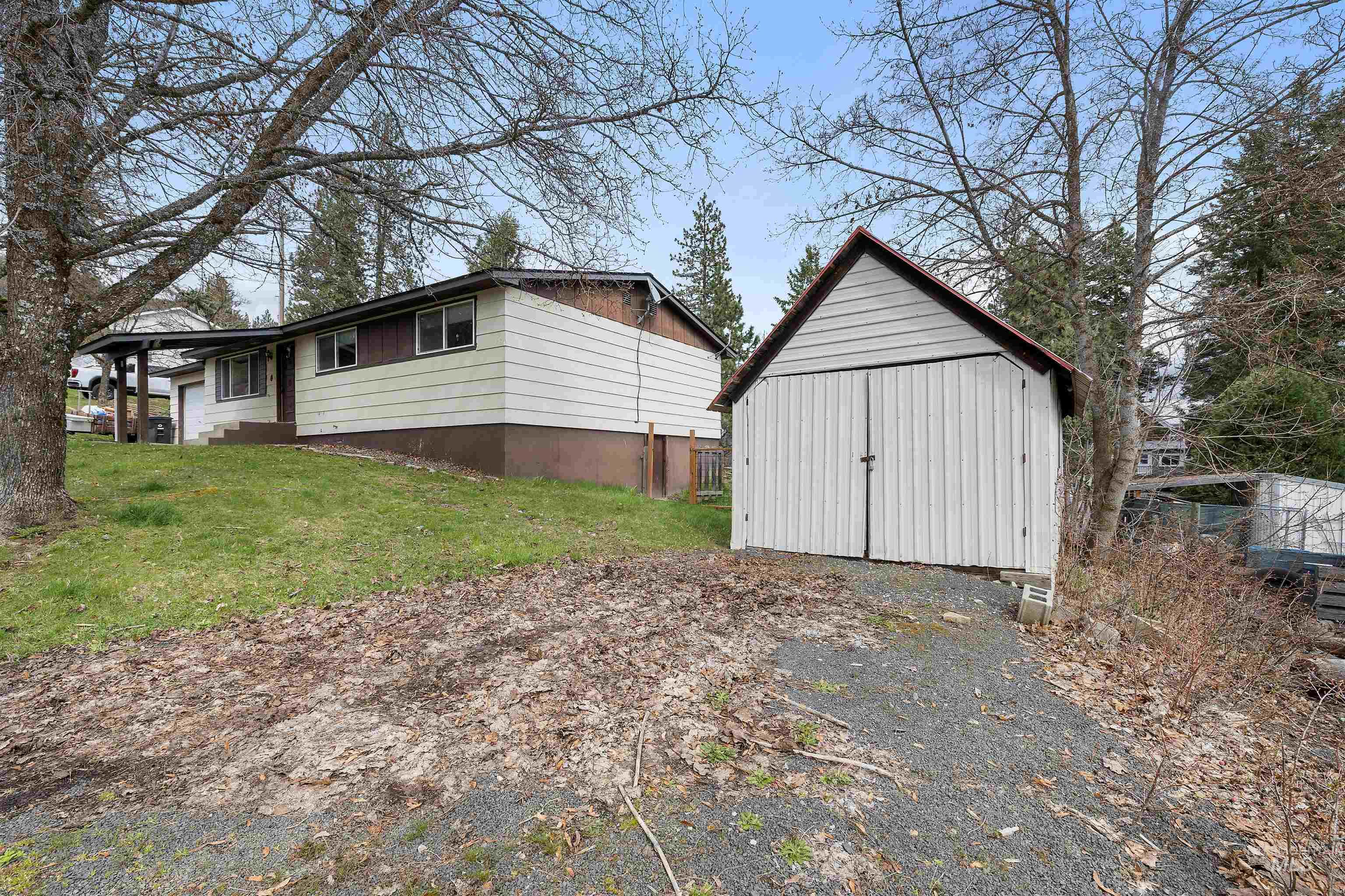 604 Line Street Deary, ID 83823 - Photo 27 of 28 View of side of home with a shed and a lawn