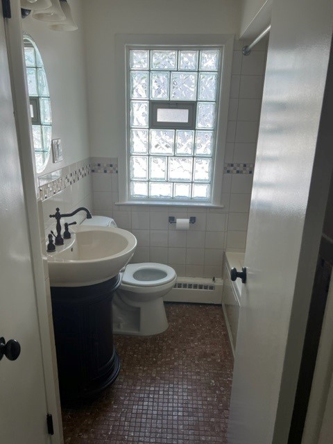 5454 West Windsor Avenue, Unit 2 Chicago, IL 60630 - Photo 11 of 12 a bathroom with a sink toilet and shower