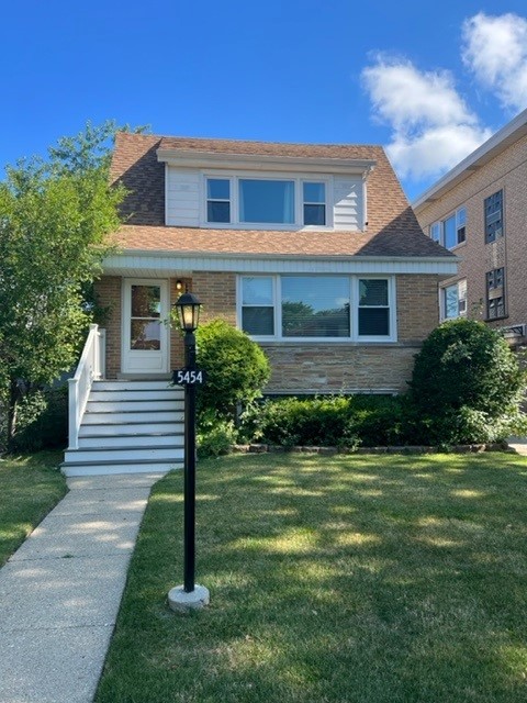 5454 West Windsor Avenue, Unit 2 Chicago, IL 60630 - Photo 2 of 12 a front view of a house with a yard