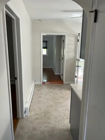 view of a hallway with wooden shelves