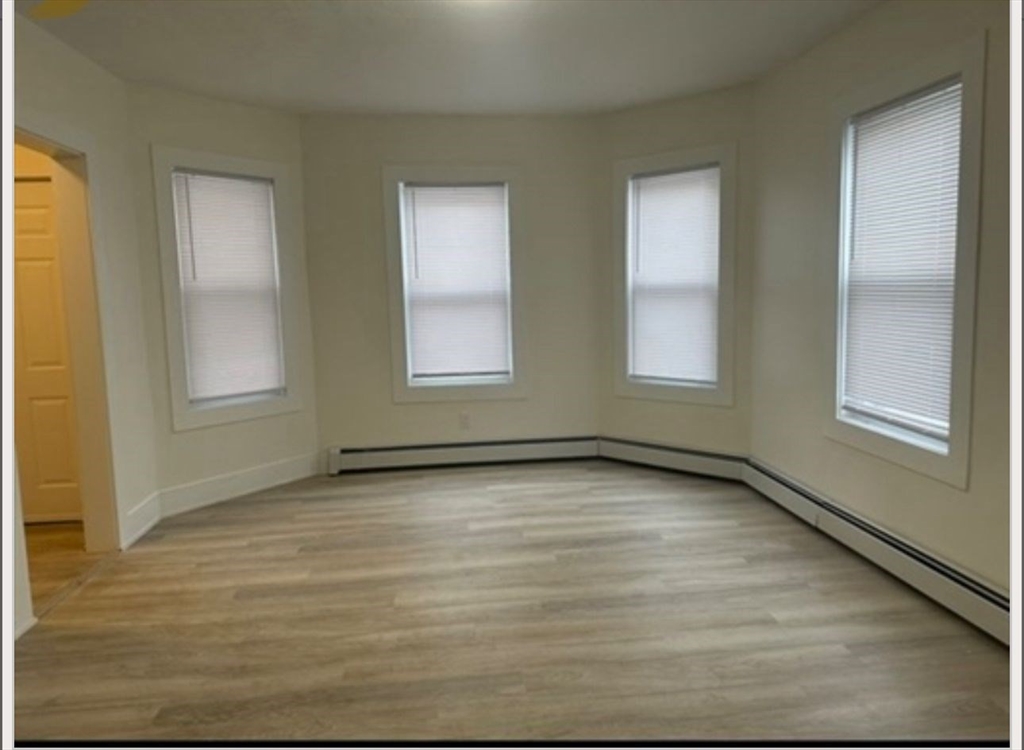 11 High Street, Unit 3 North Attleboro, MA 02760 - Photo 3 of 5 a view of an empty room with windows