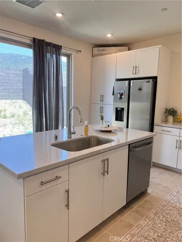 a kitchen with stainless steel appliances a sink stove and refrigerator