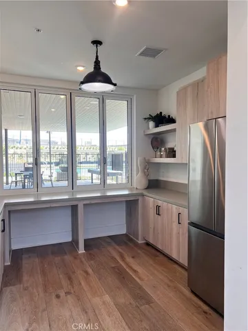 a kitchen with stainless steel appliances a stove a refrigerator and a sink