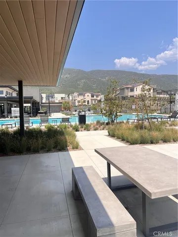 a view of swimming pool with outdoor seating and city view